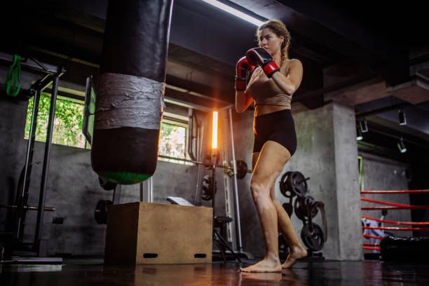 istock Barefoot boxer prepares to hit the punching bag 2172863749