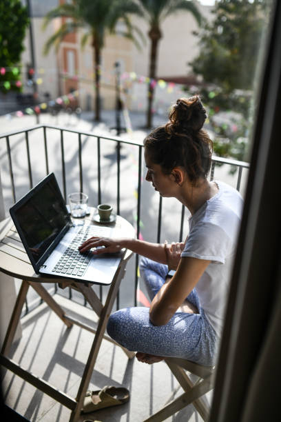 istock Female coding on a balcony with coffee and enjoying a peaceful morning in Valencia 2172864721