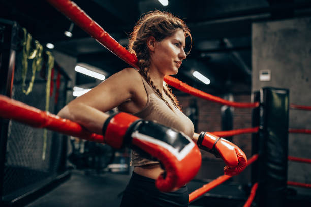 istock Boxer leaning on ropes in the ring before sparring 2172864809