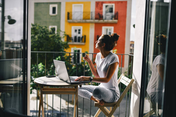 istock Digital marketer female working on a laptop from a Spanish balcony 2172864835