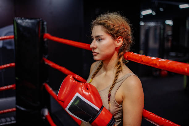 istock Boxer prepares for punch leaning against ropes 2172865221