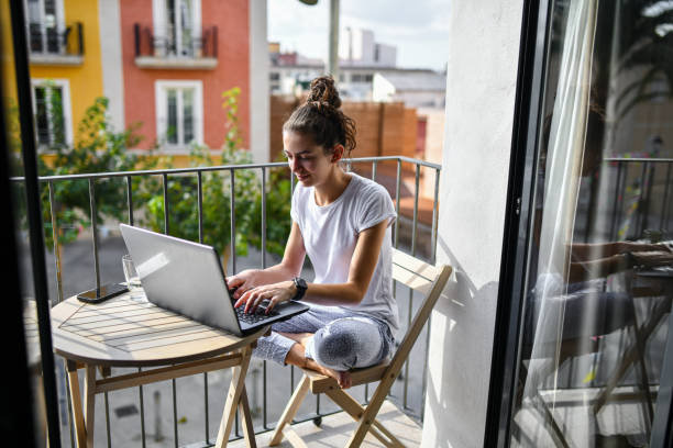 istock Female working on a laptop from a balcony in Valencia, Spain 2172865597