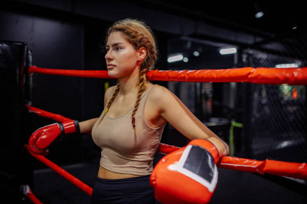 istock Boxer stands with gloves ready in the ring 2172866127