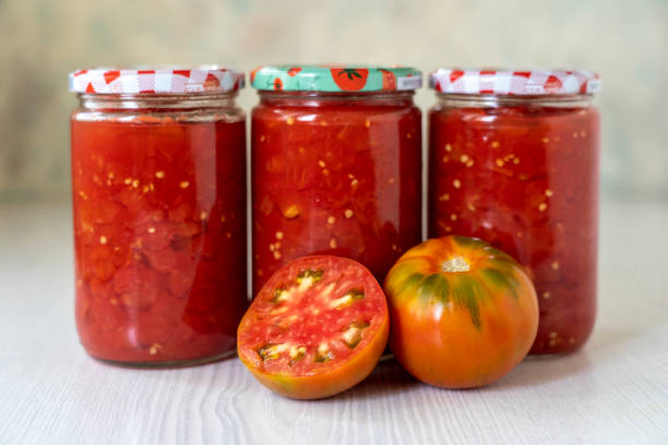 istock Tomato sauce in glass jar on white table 2172873229