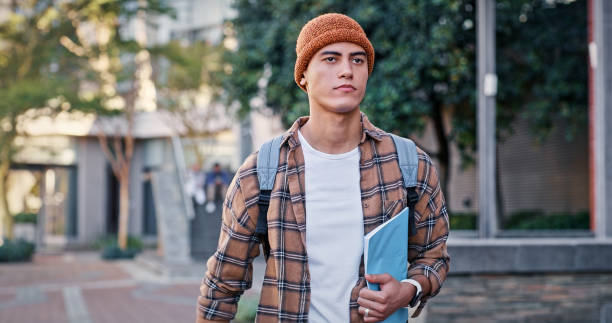 istock Man, morning commute or college student walking to class for learning, future or study in university campus. Travel, leaving or learner with book or confidence for school, education or scholarship 2172873476