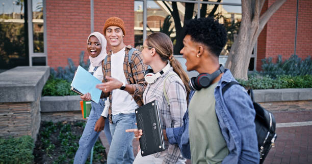 istock Friends, group and walking to college class, talking and share knowledge on module. People, learners and outside for social project discussion, speaking and together for trip to university lesson 2172873523