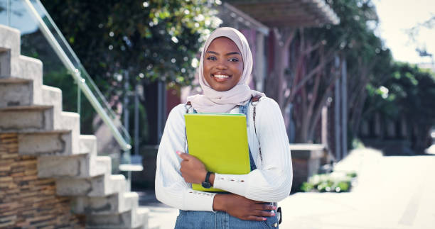 istock Muslim, portrait or college student in commute to class for learning, future or studying in university. Travel, start or happy black woman with book or confidence for school, education or scholarship 2172873572