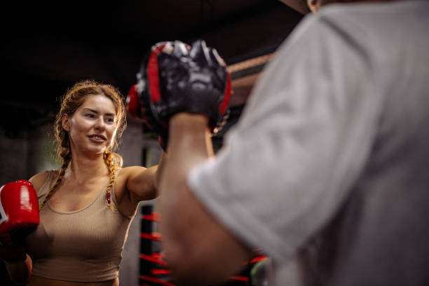 istock Woman engages in sparring session with boxing partner. 2172874124