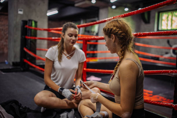 istock Women sitting in ring having pre-match motivational talk. 2172879351