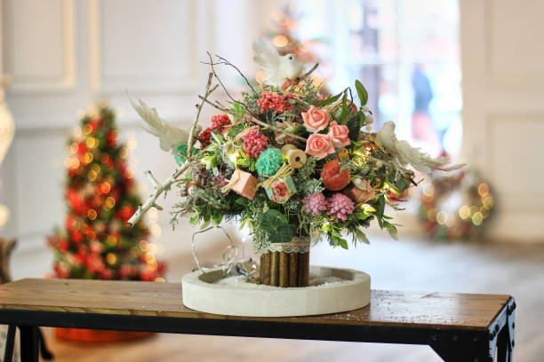 winter christmas bouquet with roses and birds on the window
