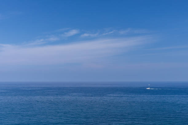 istock white boat sailing on the ocean, horizon and bright blue sky 2172882645