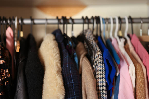 No people open wardrobe clothes and three cardboard boxes. clothes are sorted into boxes by Keep Discard and Donate categories. Decluttering. Analysis. Zero Waste. Arranging clothes at wardrobe