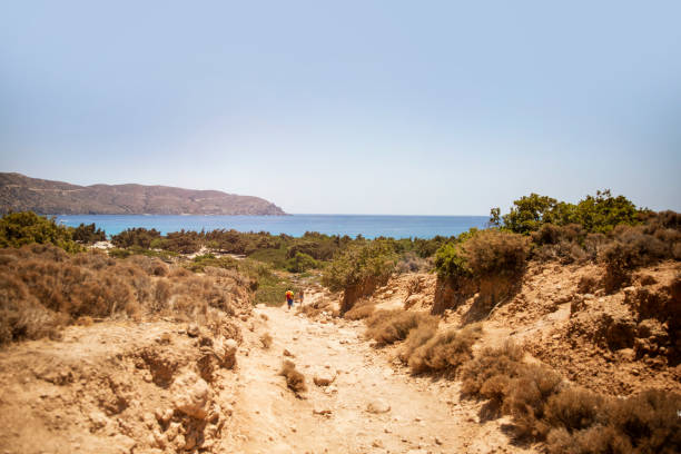 Dry rocky Footpath to the blue sea beach