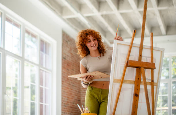 istock Young painter with curly hair immersed in artwork. 2172883238