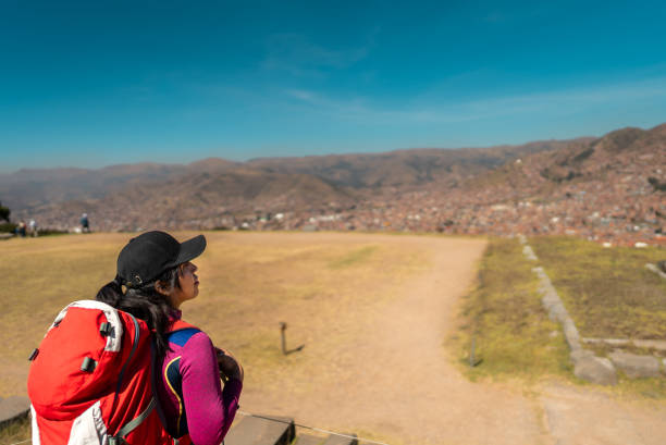 Young traveler woman looking at view on Cusco, Peru