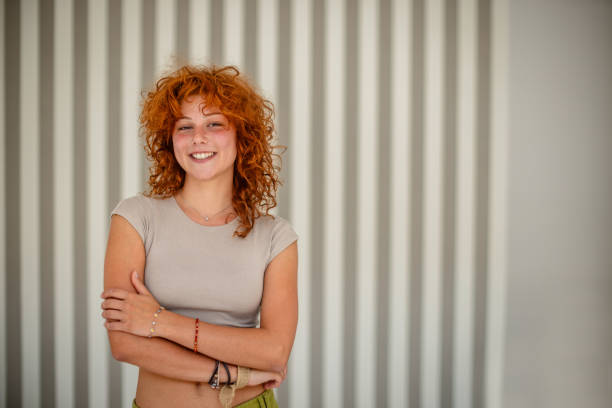 istock Young woman confidently stands with arms folded left 2172883902