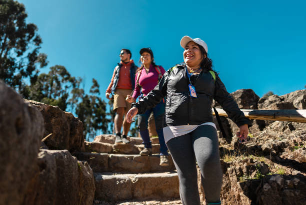 Tour guide woman talking with tourists in Cusco, Peru