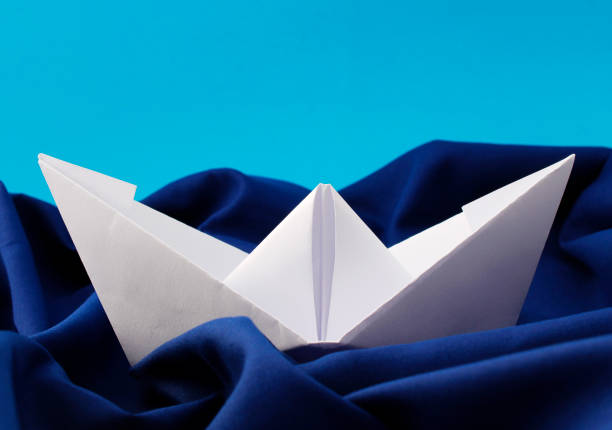 White paper boat calmly dodging the waves
