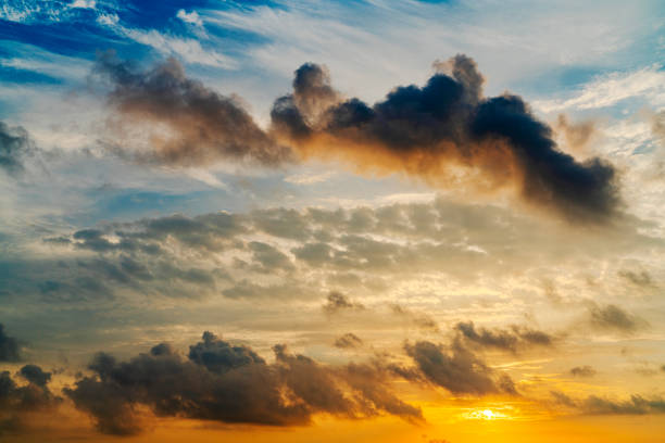 Dramatic yellow sunrise or sunset with dark clouds