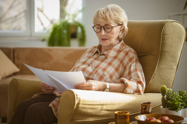 istock Worried senior woman reading documents 2172889370