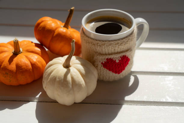 istock Coffee cup on wooden table with pumpkins 2172890909