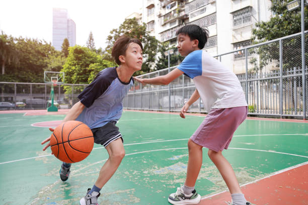 istock Two boys playing basketball 2172893670