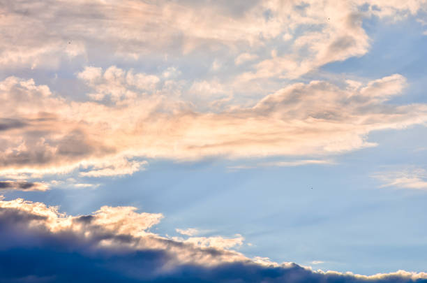 The sky is blue with a few clouds. The sun is shining through the clouds, creating a beautiful and peaceful scene