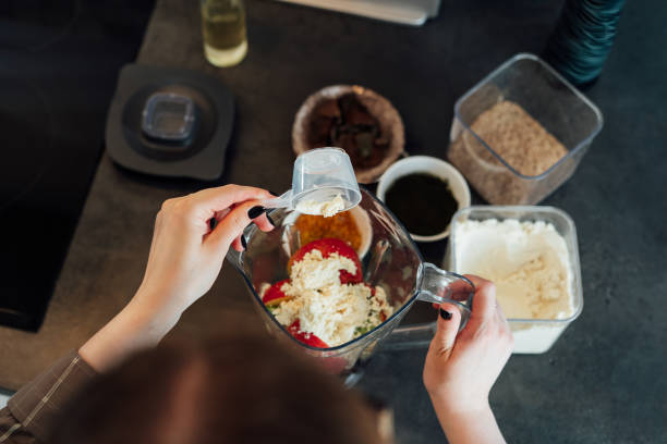 istock Close up top view woman adding plant based pea protein powder during making smoothie on the kitchen. Superfood supplement. Healthy nutritional vegan diet. Healthy dieting eating, weight loss program. 2172894141