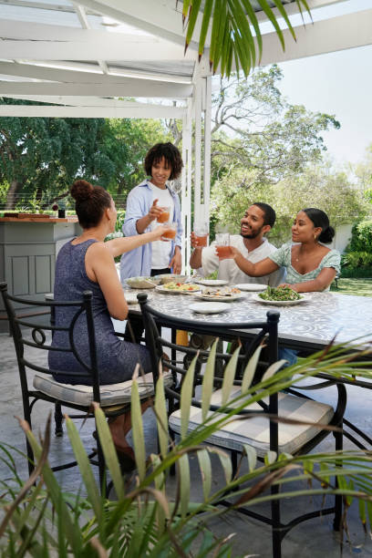 istock Smiling fiends enjoying meal on patio 2172895074