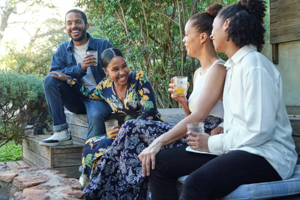 istock Smiling friends enjoying drinks in garden 2172896197