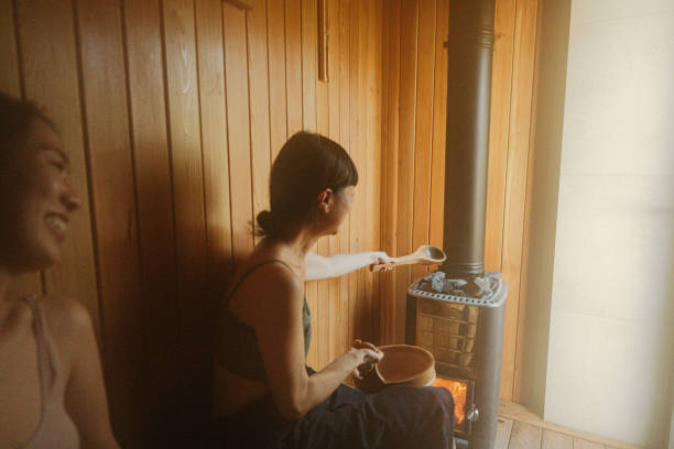 Close-up of a traditional sauna heater filled with stones ready for steam. The rustic interior with brick and wood walls evokes warmth, relaxation, and wellness. Perfect for spa or health-themed concepts.