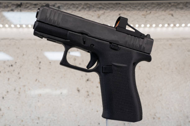 istock The best modern compact pistol for self-defense with a red dot sight. 2172896699