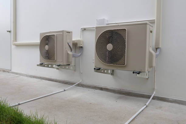 istock Air conditioner compressor installed in old building. Outdoor split wall type air conditioner compressor unit inverter installed on the outside of the building. Air conditioner compressor outdoor unit 2172898129