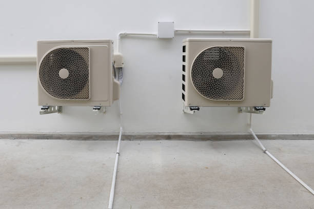 istock Air conditioner compressor installed in old building. Outdoor split wall type air conditioner compressor unit inverter installed on the outside of the building. Air conditioner compressor outdoor unit 2172898139