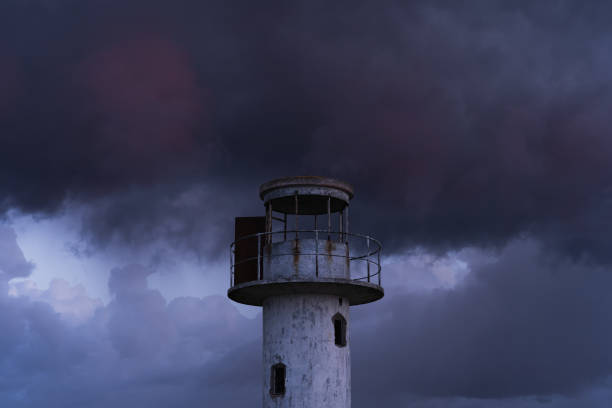 istock The old Neeme lighthouse against the backdrop of thunderclouds after sunset in twilight. 2172898219