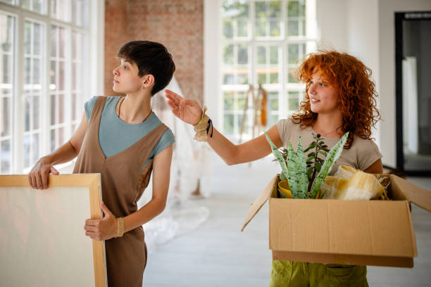 istock Two friends excitedly planning room decoration tasks. 2172900848