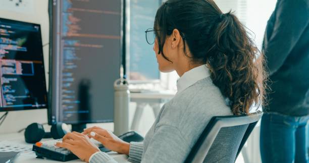 istock Closeup of tech team professionals collaborate working together on software development in contemporary office. Software developer, artificial intelligence and programming. 2172905714