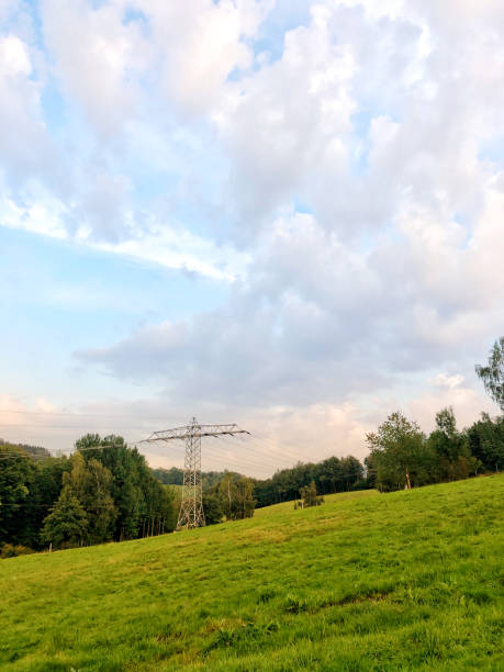 istock rural landscape at sunset, with a towering electricity pylon 2172911483