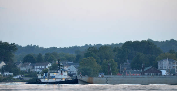 Tug Boat with Barge going up the Susquehanna river at Dusk