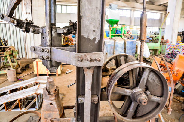 istock A machine with a wheel on it is in a dirty, cluttered workshop 2172913589
