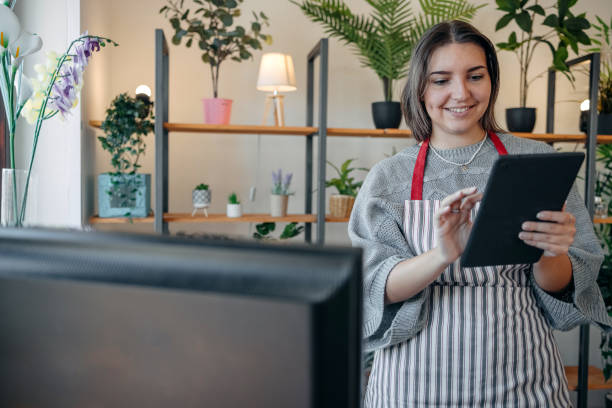 istock Young people starting new business working at small botany shop and using digital tablet to make orders 2172914695