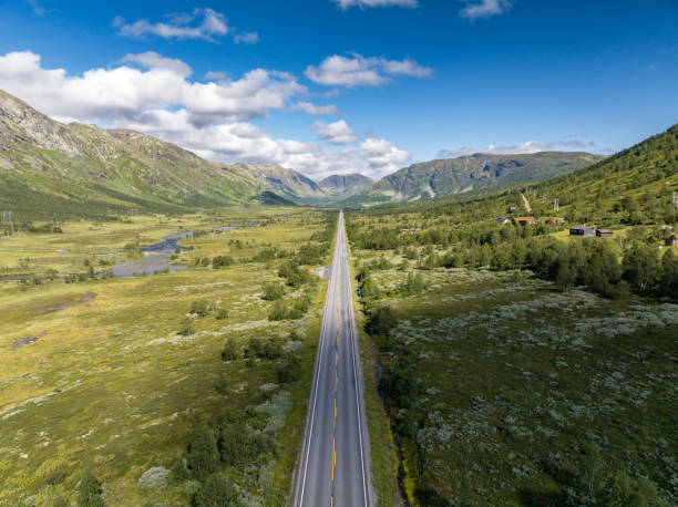 Endless straight road through mountain valley