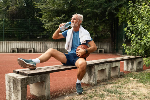 istock Senior Man Relaxing After a Run Hydrating 2172916954