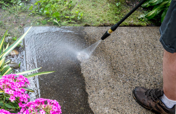 istock Man washing off dirt off the concrete surface, close up view. 2172918180
