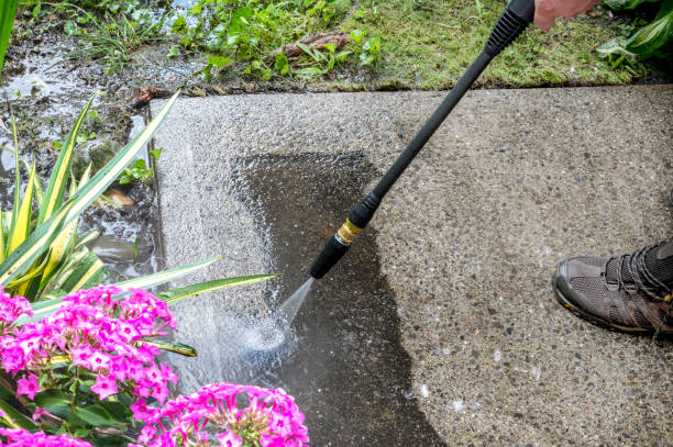 istock Man washing off dirt off the concrete surface, close up view. Pearson uses power washer, spring cleaning. 2172918505