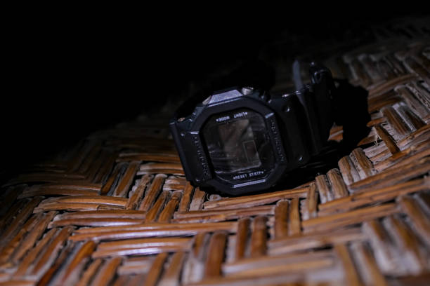 digital watch product on woven board isolated on dark background