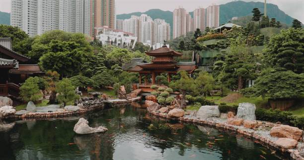 istock Serene Asian garden with traditional pavilion, lush greenery, and koi 2172920230