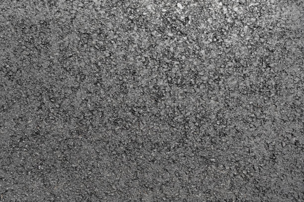 Asphalt background texture with some fine grain with road