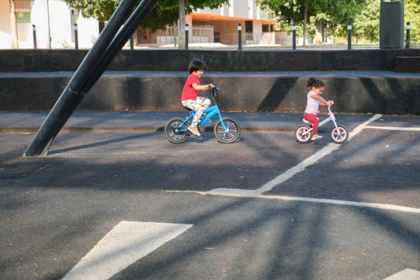 istock Children riding bikes outdoors in urban park 2172923707
