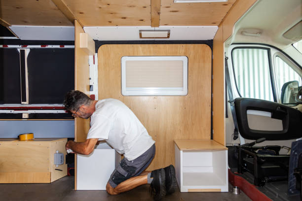 camper van conversion. installing chairs, seat box in a camper van. - edificio reconvertido fotografías e imágenes de stock